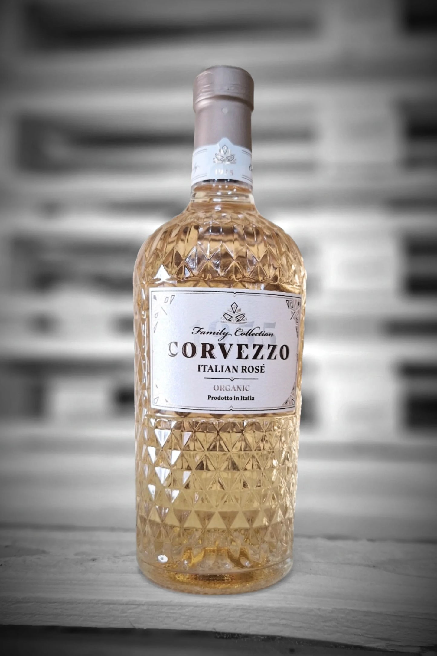 Fles Corvezzo Rosé tegen vervaagde loodsachtergrond – Mixdoos B (6× Rosé)
